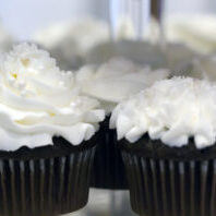 Close shot of chocolate cupcakes with white frosting.